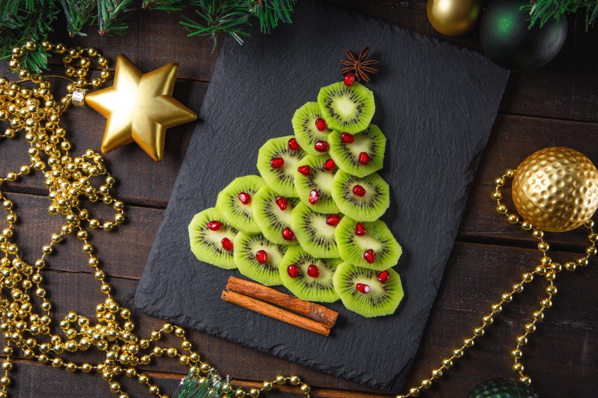 a Christmas tree made with kiwi and berries